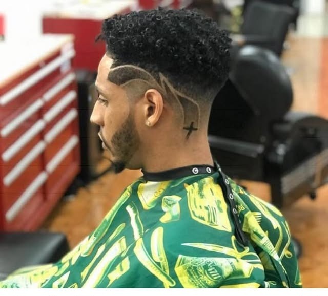 Curly fade with hairline design detail